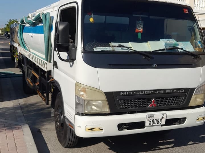 a truck with a large truck on the side of the road