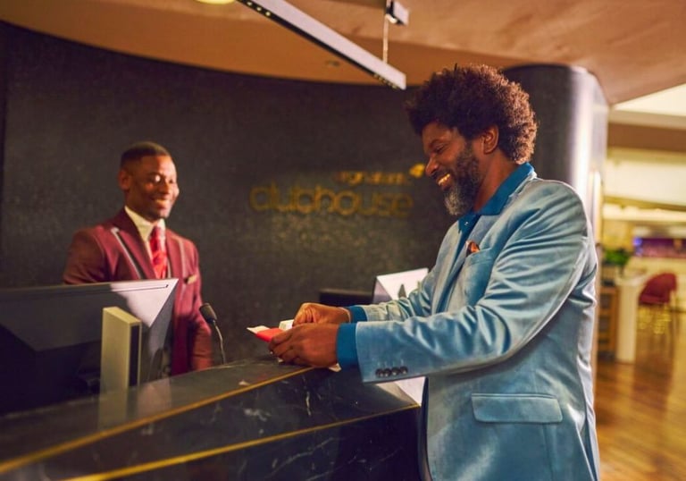 Man in suit checking in to Virgin Atlantic Clubhouse London Heathrow - Airport Lounge Guide