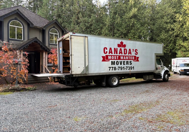 Canada’s Most Wanted Movers truck parked at a forest-side home in the Lower Mainland during a residential move.
