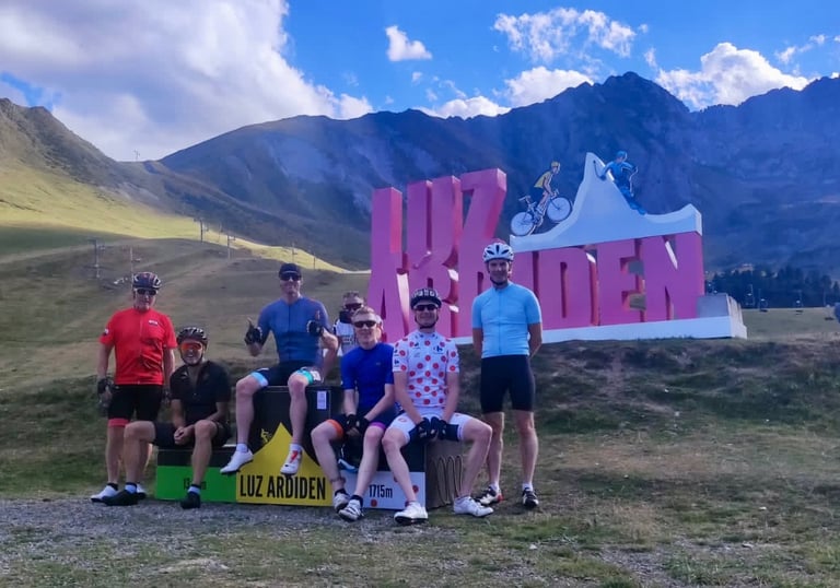 a group of people standing in front of a sign that says Luz Ardiden