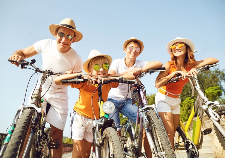 a family of three people riding bikes on a sunny day