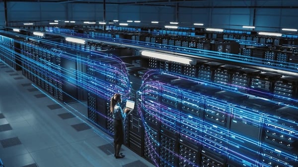 a man standing in a server room with a large amount of data and data