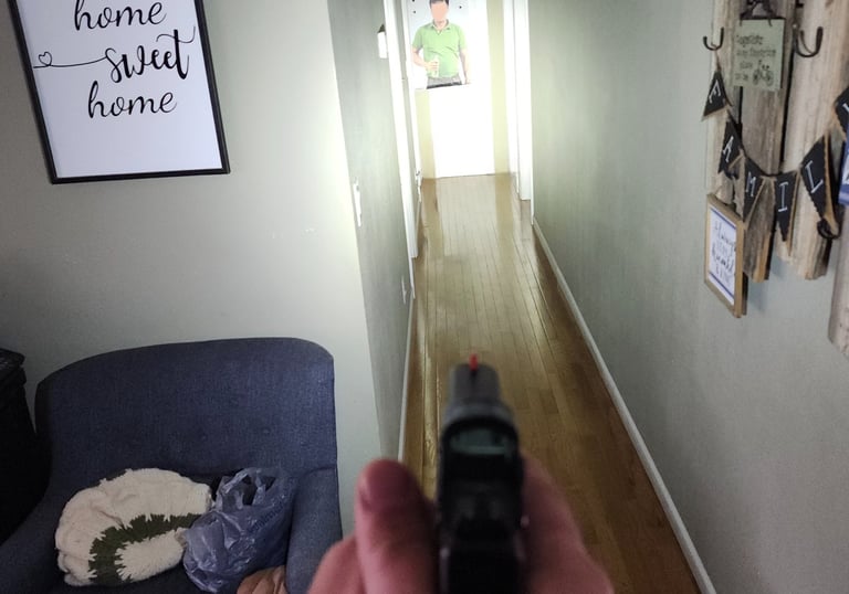 Individual using a personal firearm and self-defense tactics during home defense training.