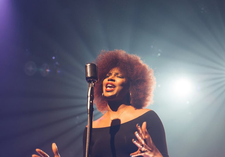 a woman in a black dress and a microphone