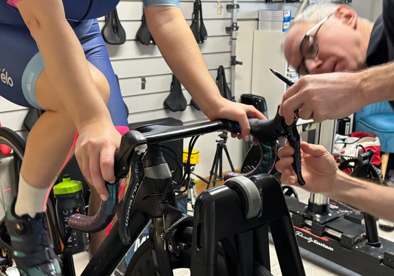 Close-up of a bike fitter adjusting a customer's bike