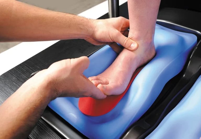 Close-up of a bike fitter forming custom insoles.