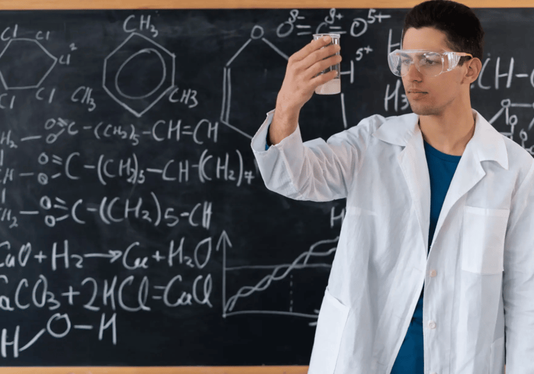 a man in a lab coat and goggles holding a cell phone