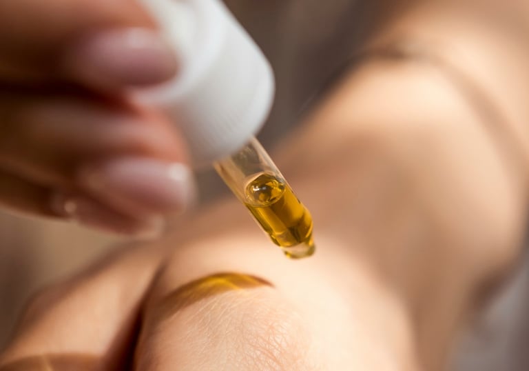 Applying oil with a dropper pipette to hand