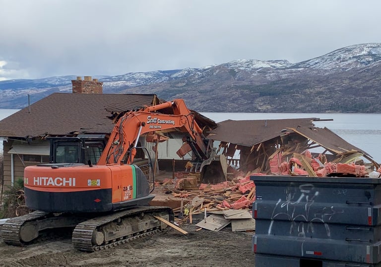 excavator demolishing a residential structure