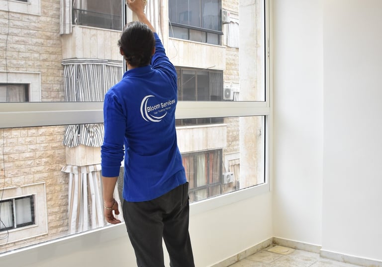 a man standing in front of a window with a window