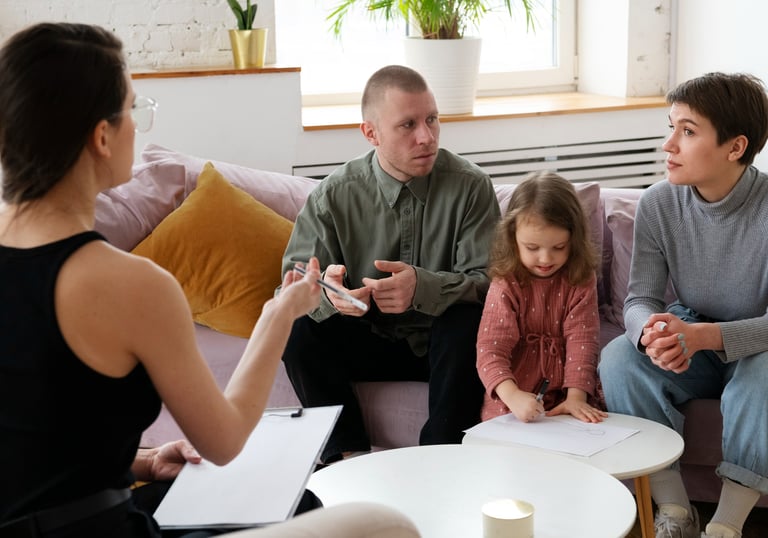 a woman and two men sitting on a couch