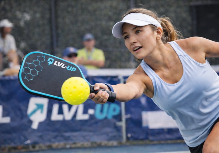 Competitive pickleball player hitting a shot during match play.