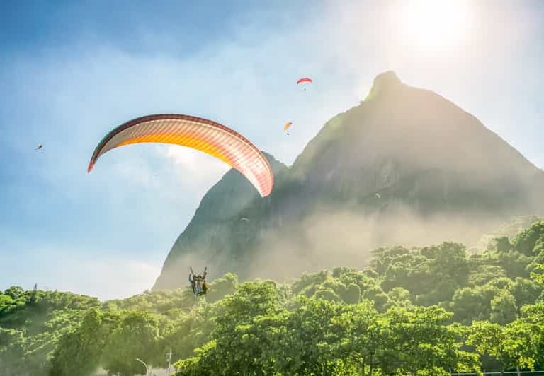 a person parasailing over a mountain