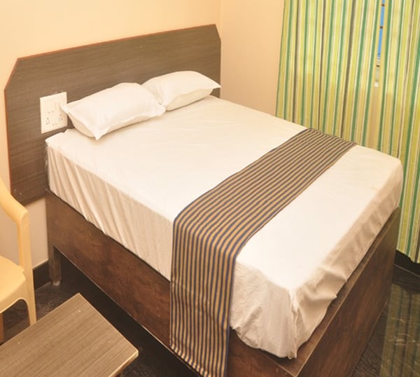 Clean and comfortable room at Hotel Aishwariyam Thirukadaiyur hotel near Abirami Temple