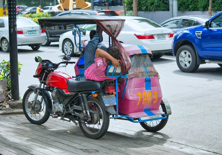 Colorful Filipino tricycle taxi on a busy street, showcasing local transportation and vibrant street life in the Philippines
