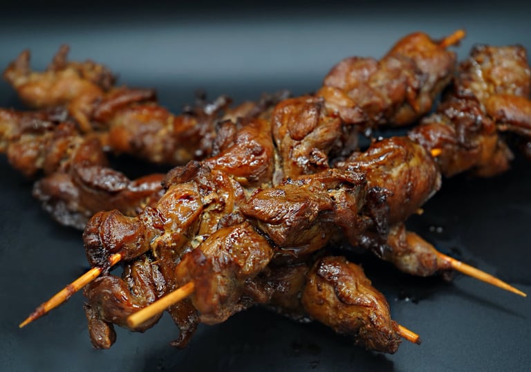 4 Grilled Teryaki Chicken Kabobs with 2 in the background and 2 in the foreground,