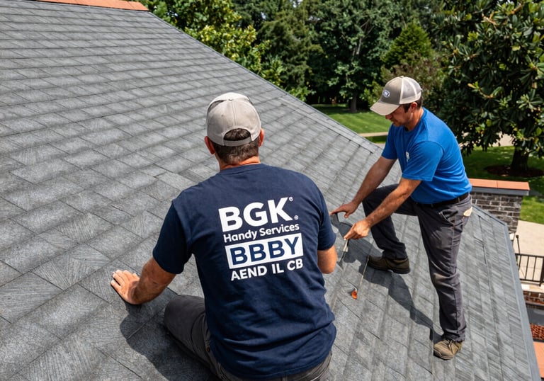 Professional roofing contractors from BGK Handy Services inspecting gray roof shingles for repair.