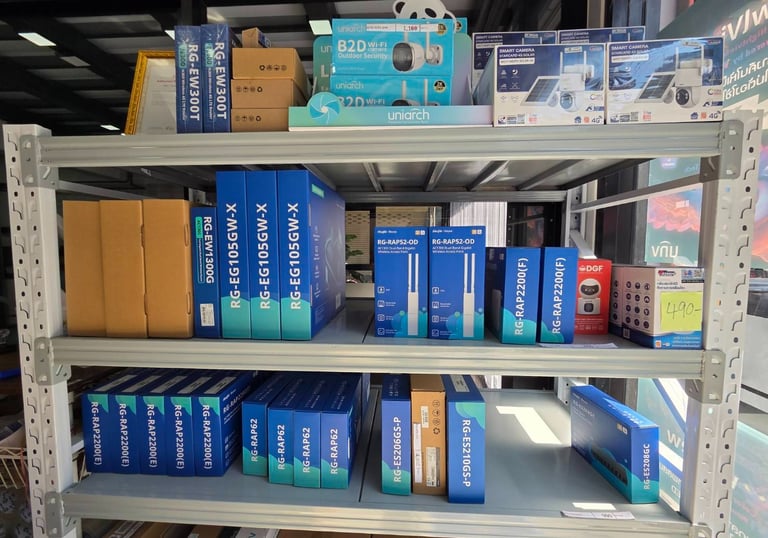 a shelf of boxes of various types of electronics