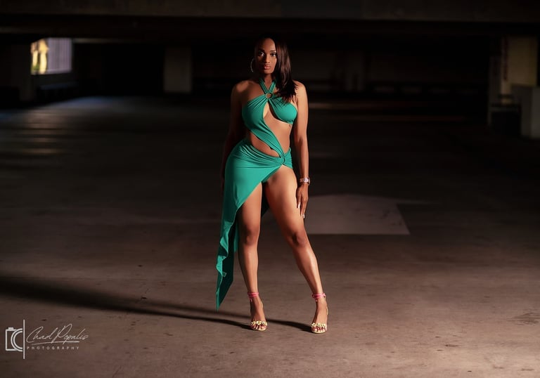 a woman in a green dress standing in a parking lot