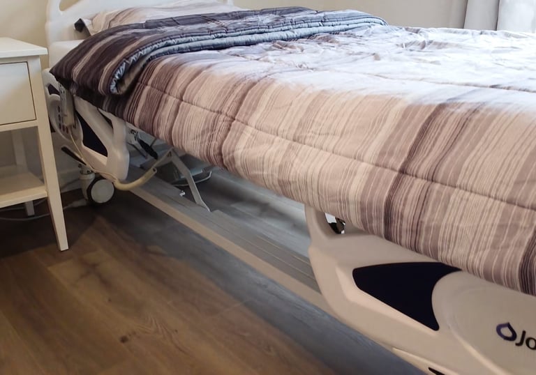 Adjustable medical bed in a comfortable AFH room, supporting safe rest, mobility, and daily care for residents.