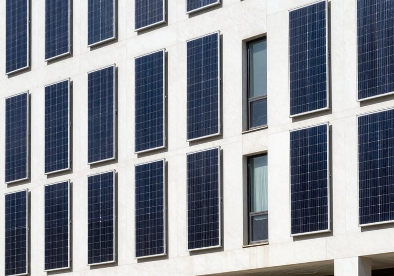 A bright, clean exterior shot of a modern commercial building in a Global Hispanic city, featuring vertical solar arrays integrated into the facade design. Daylight photography, professional style.