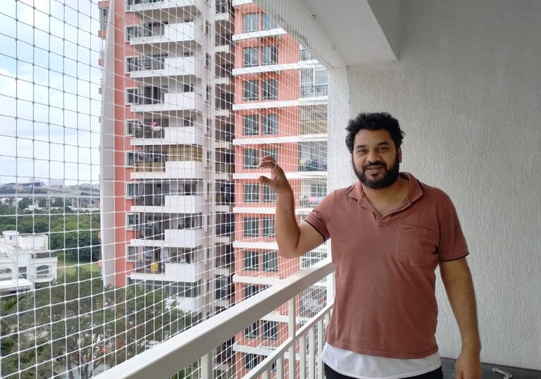 Transparent pigeon net installed on a Pune apartment balcony to prevent pigeons and nesting.