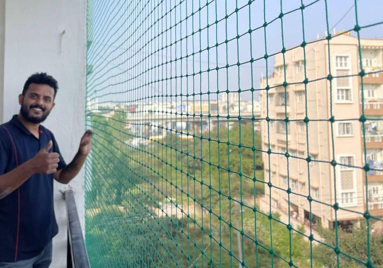 Close-up of hands repairing a balcony safety net with tools in natural light.
