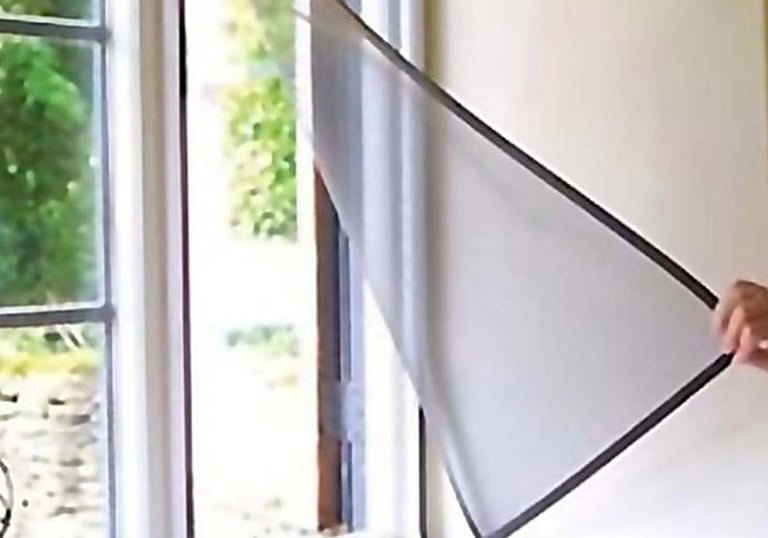 Wide shot showing a balcony fully covered with mosquito nets secured by velcro strips.
