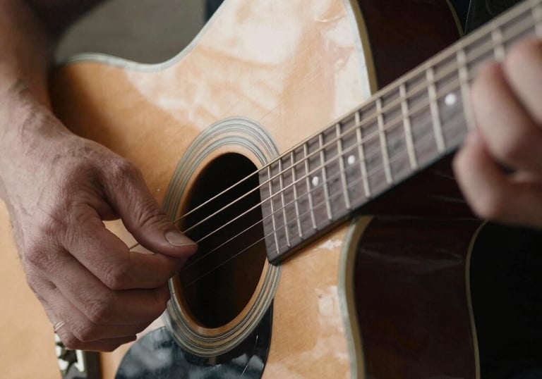 A close-up of a frothy pint of craft beer beside a cocktail glass garnished with fresh herbs.
