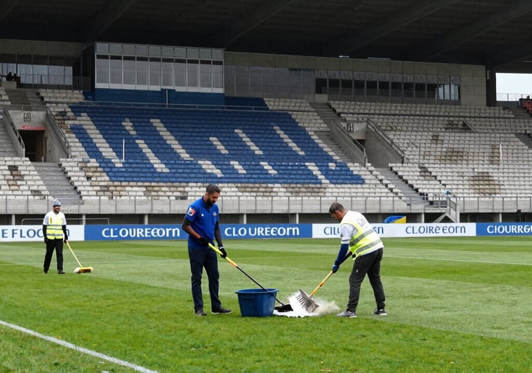 A spotless and organized professional kitchen in a Southern European restaurant, with polished steel surfaces and a bright, clean floor. Detailed focus on sanitation and professional standards.