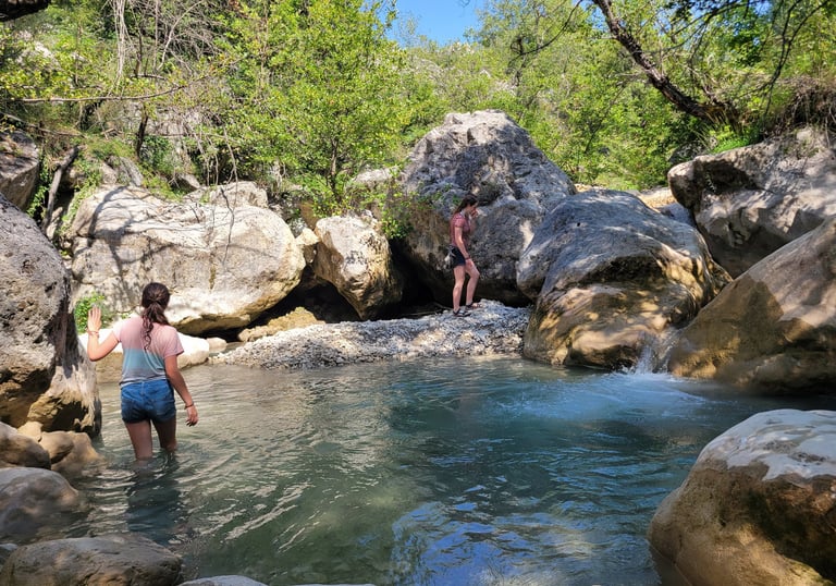 two women standing in a stream of water