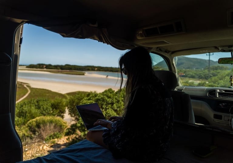 a woman sitting in the back of a van