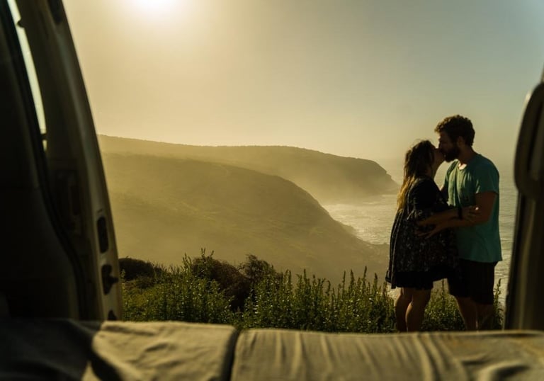 a couple standing in the open door of a van