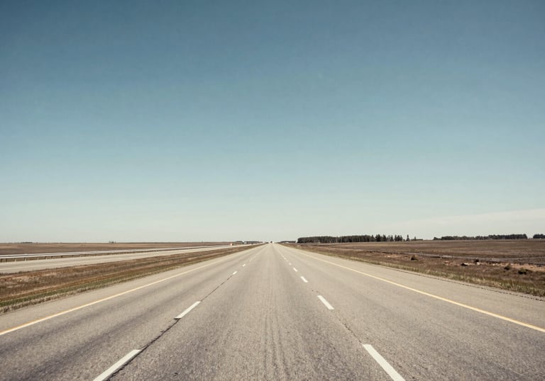 An wide-angle photography of a clean North American highway stretching toward the horizon under a clear sky. The image conveys safety and reliability, with cool blue and off-white lighting.