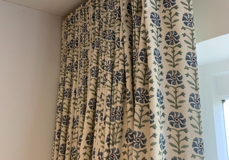 Bespoke curtains with single pleat heading hanging on a neat curved ceiling track supplied by me