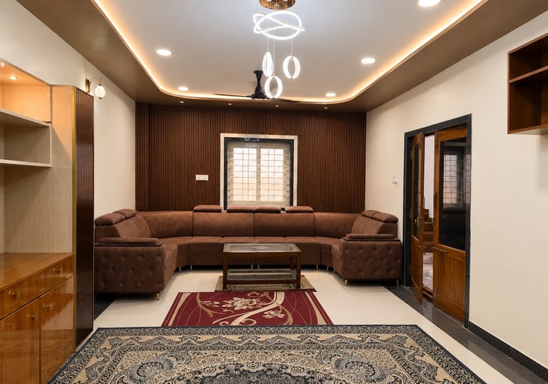 Modern living room featuring a brown sectional sofa, wood slat wall, and elegant chandelier lighting.