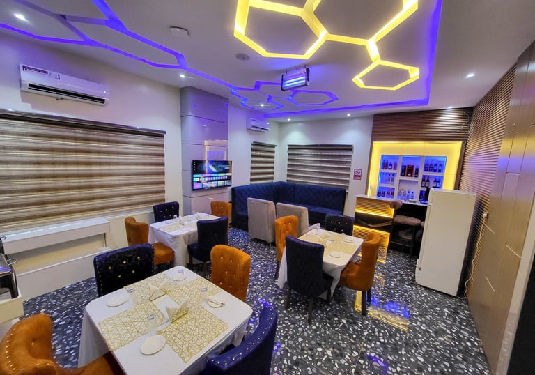 A vibrant restaurant interior with guests enjoying meals and drinks.
