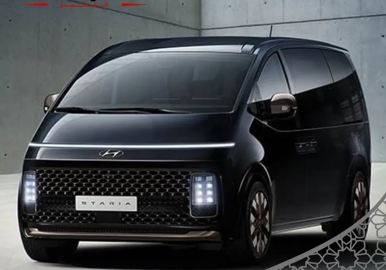 A friendly driver assisting passengers with luggage at Jeddah airport.