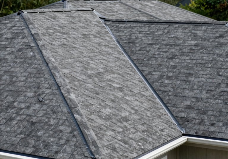 A freshly completed residential roof with clean flashing and gutters, set against a backdrop of green trees, North American / US.