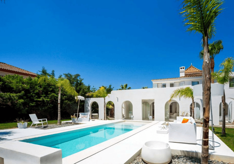 Rectangular Mediterranean pool with bright turquoise water and crisp white tiling for a clean coasta