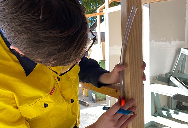 A person using a water level