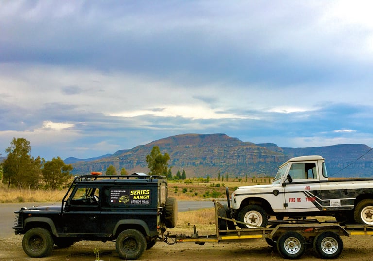 a land rover with a flatbed trailer attached to it
