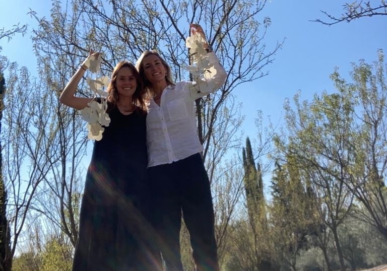 a man and woman standing in a park