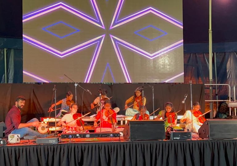 A picture of children ensemble performing at an event