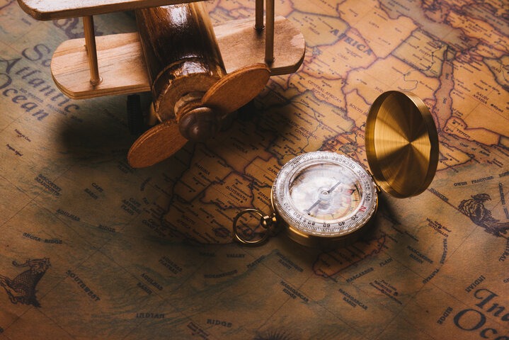 a pocket watch with a compass on a map