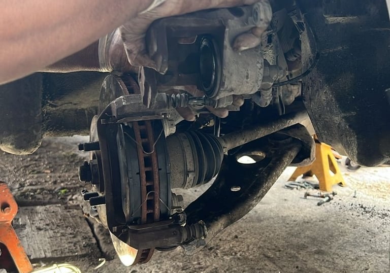 a person is working on a car's brake