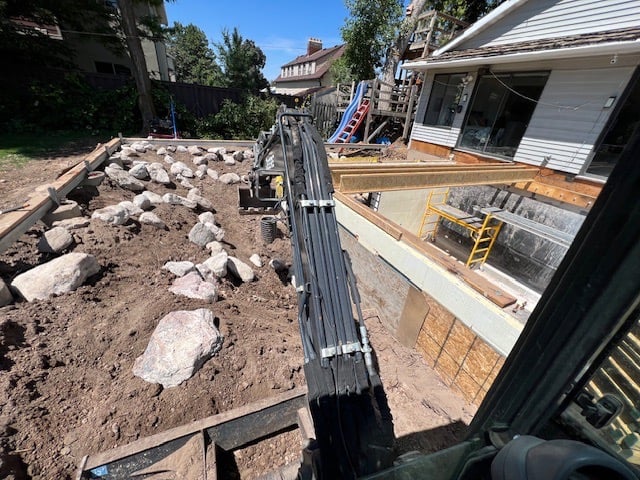 POV operating and excavator building a retaining wall 