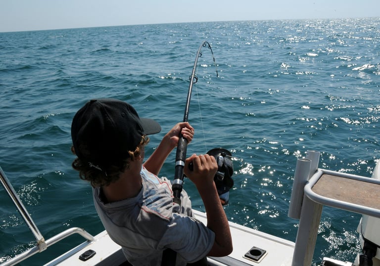 a man is fishing in the ocean with a fishing rod