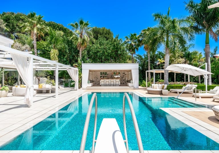 Villa Serenity pool with pergola, bar, and sun loungers under tropical palms