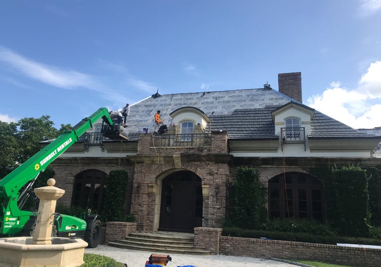 Roof tile material loaded using a lift due to the 10/12 pitch on the roof 